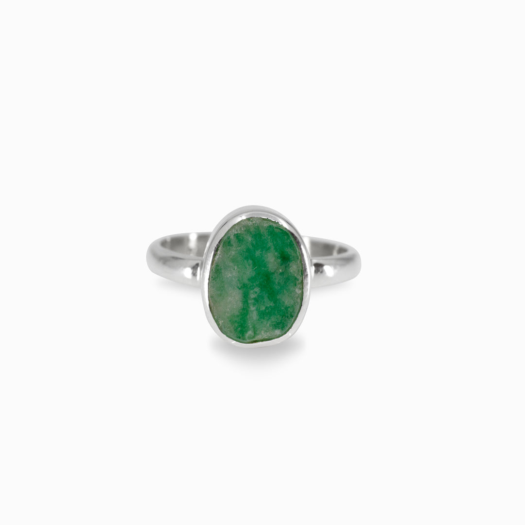 Silver ring with a green stone on a white background