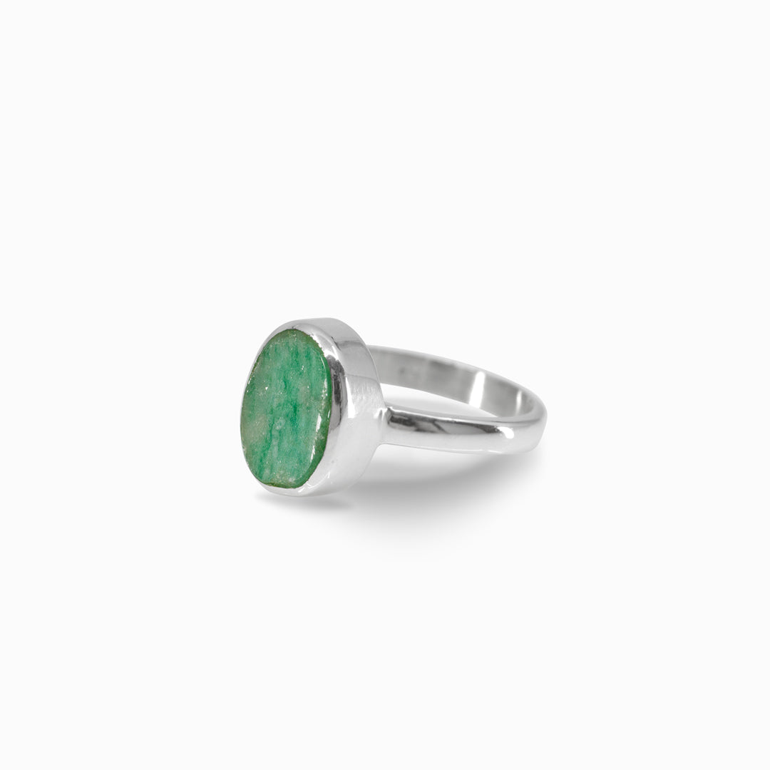 Silver ring with a green stone on a white background