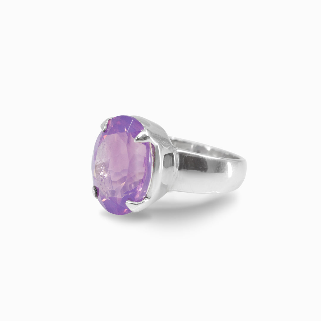 Silver ring with a purple gemstone on a white background