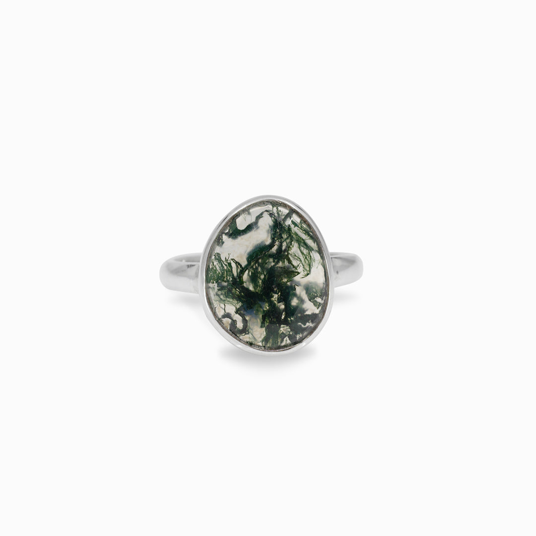 Silver ring with a green marbled stone on a white background
