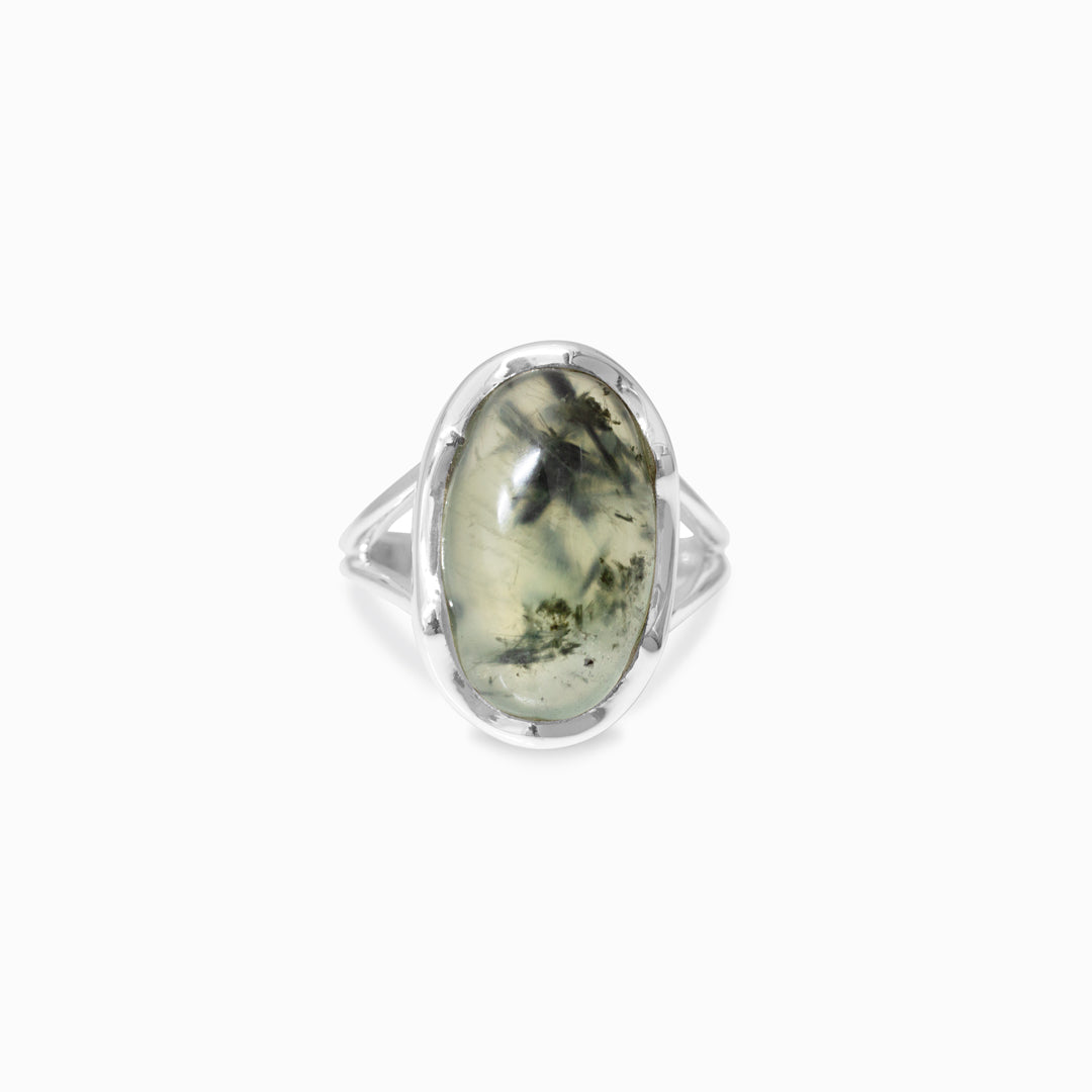 Silver ring with a green stone on a white background