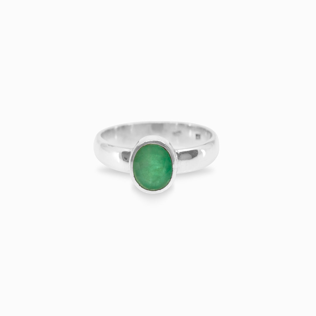 Silver ring with a green gemstone on a white background