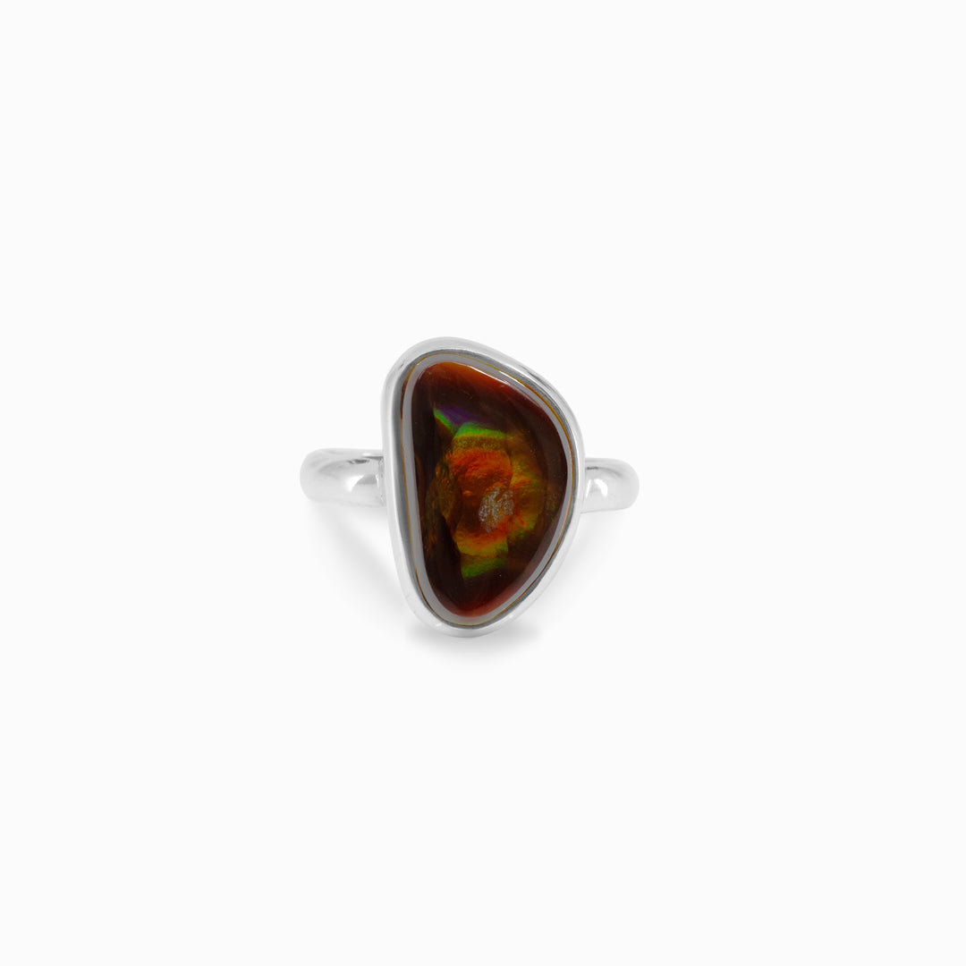 Silver ring with a brown and green freeform stone on a white background