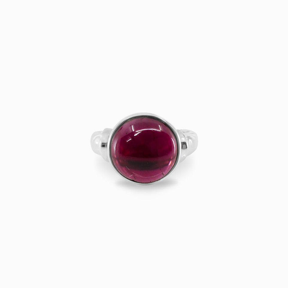Silver ring with a red gemstone on a white background
