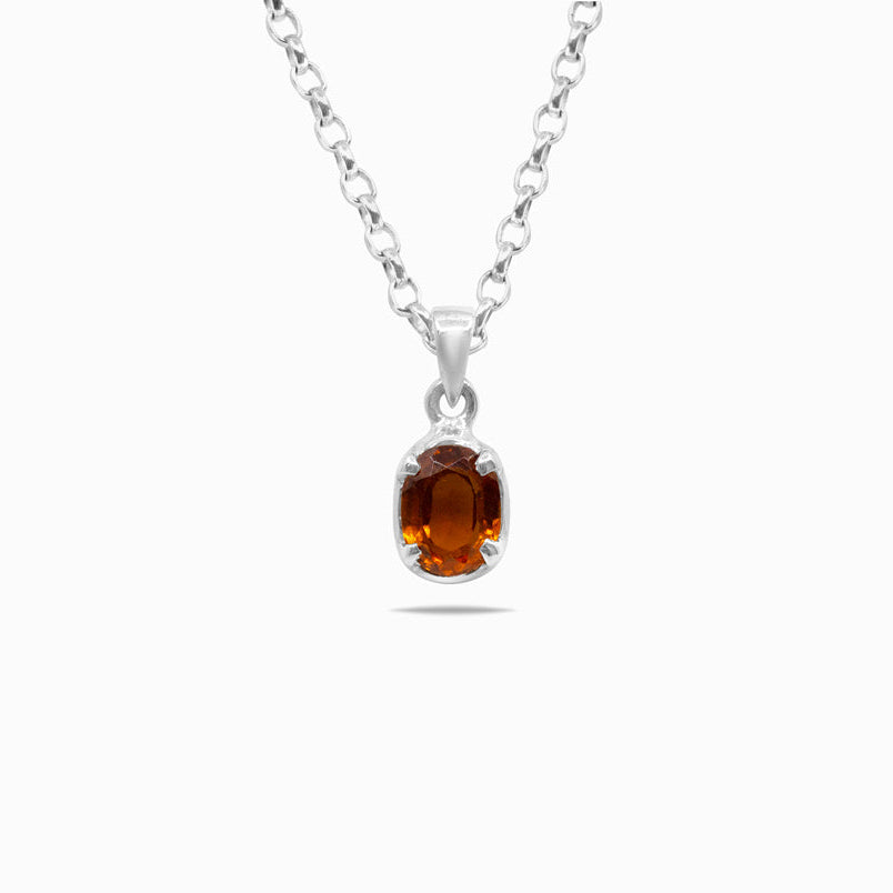 Silver necklace with a pendant featuring an orange gemstone on a white background