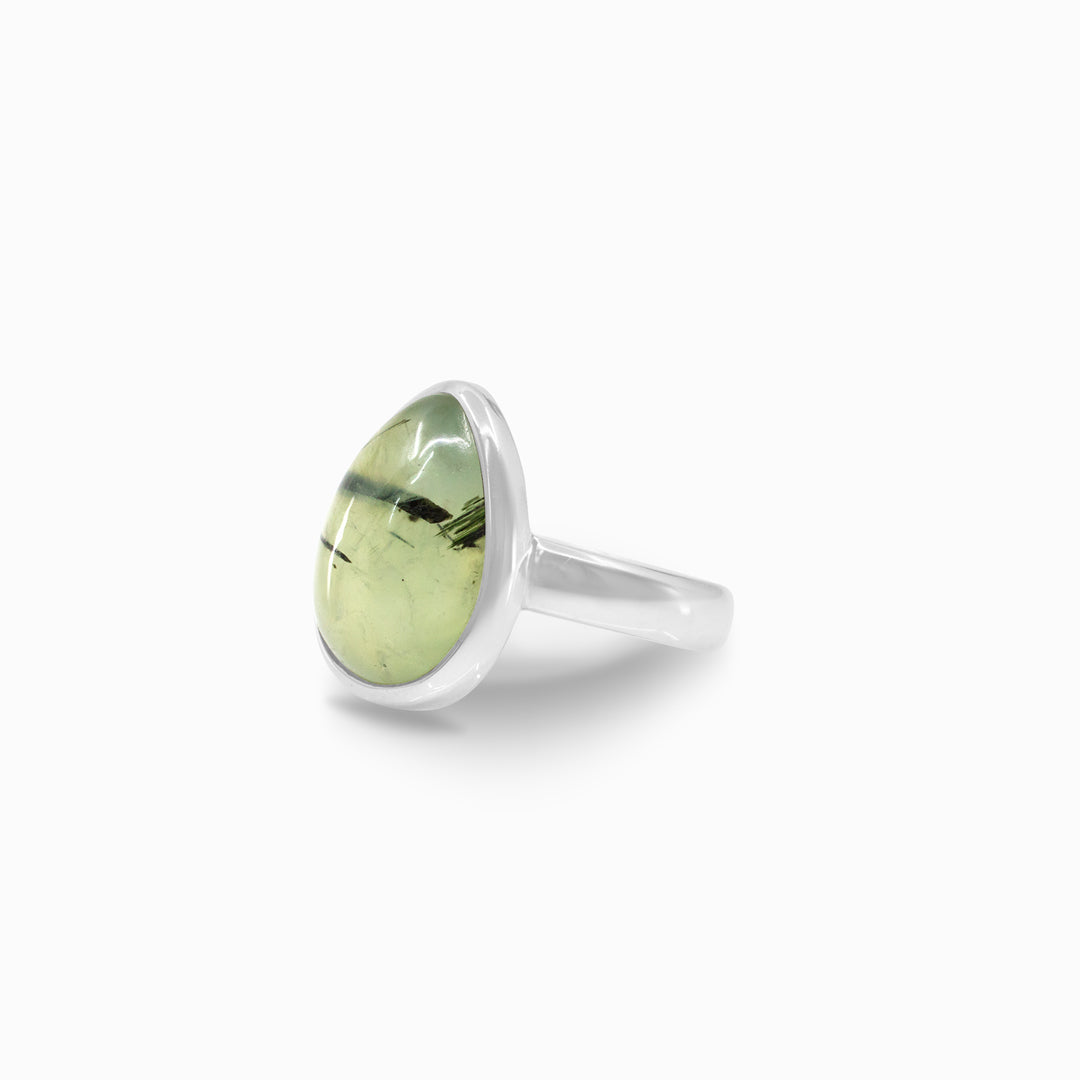 Silver ring with a light green teardrop-shaped gemstone on a white background