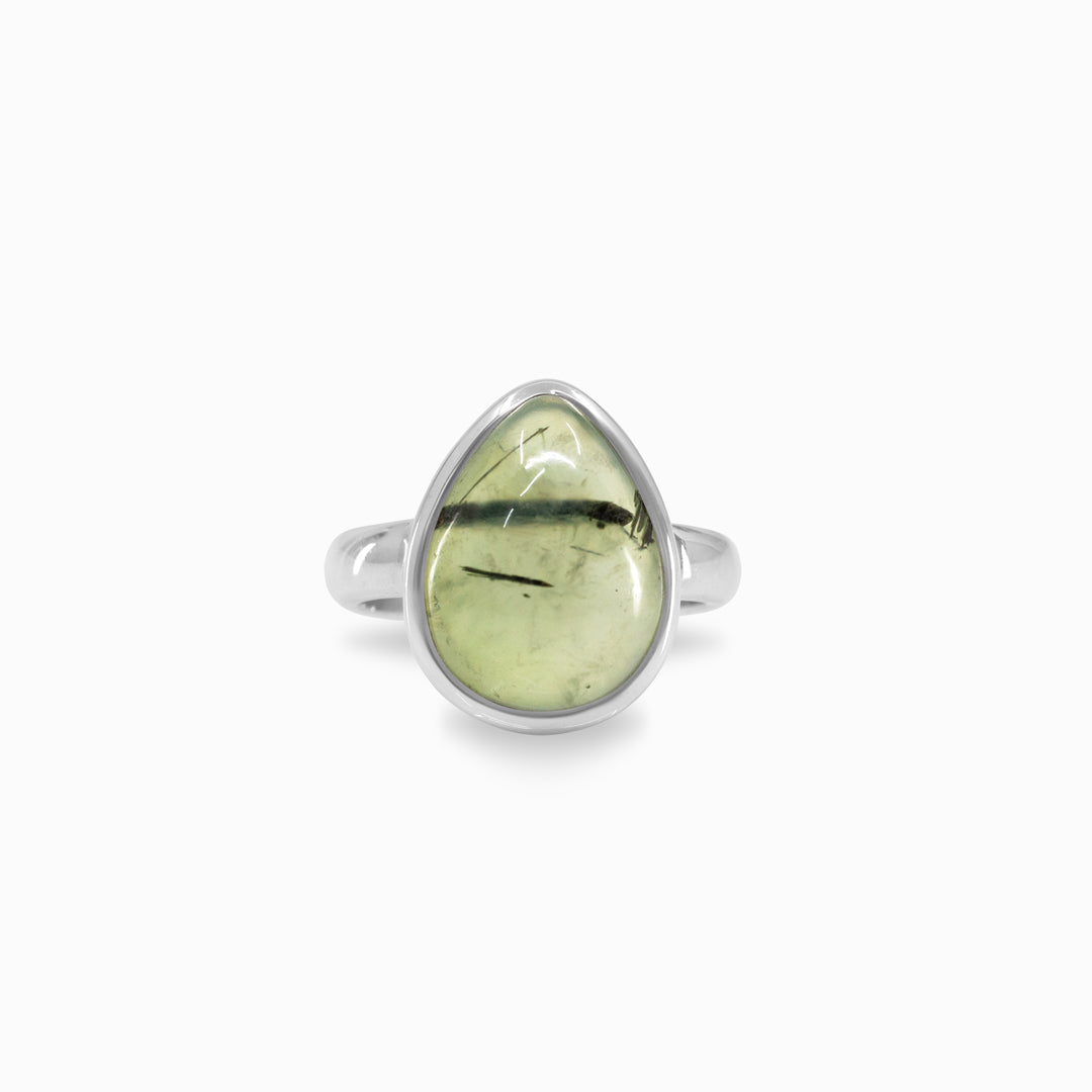 Silver ring with a light green teardrop-shaped gemstone on a white background
