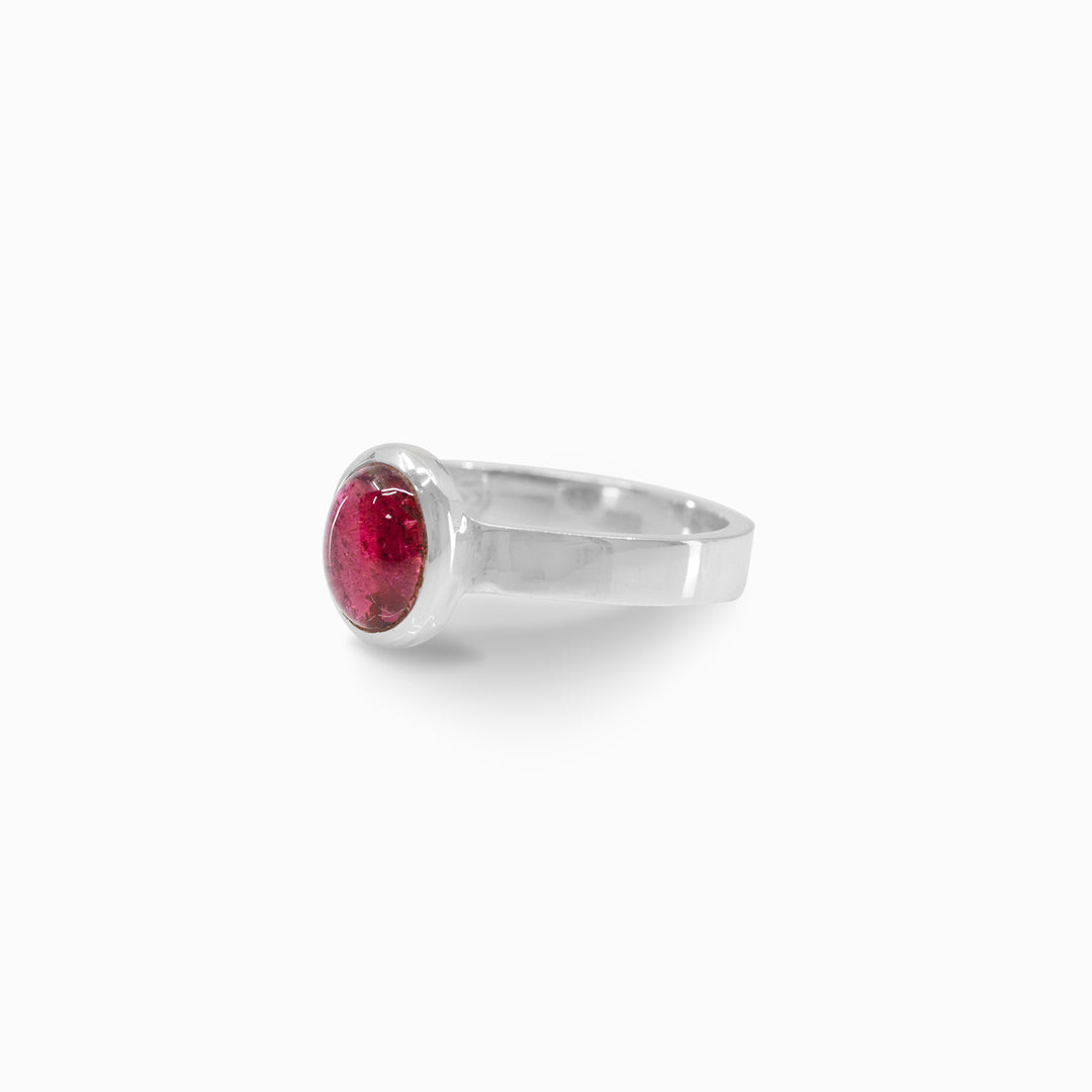 Silver ring with a pink gemstone on a white background
