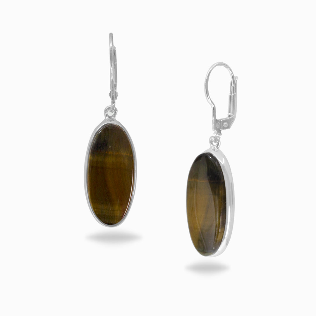 Pair of oval-shaped silver earrings with brown stones on a white background