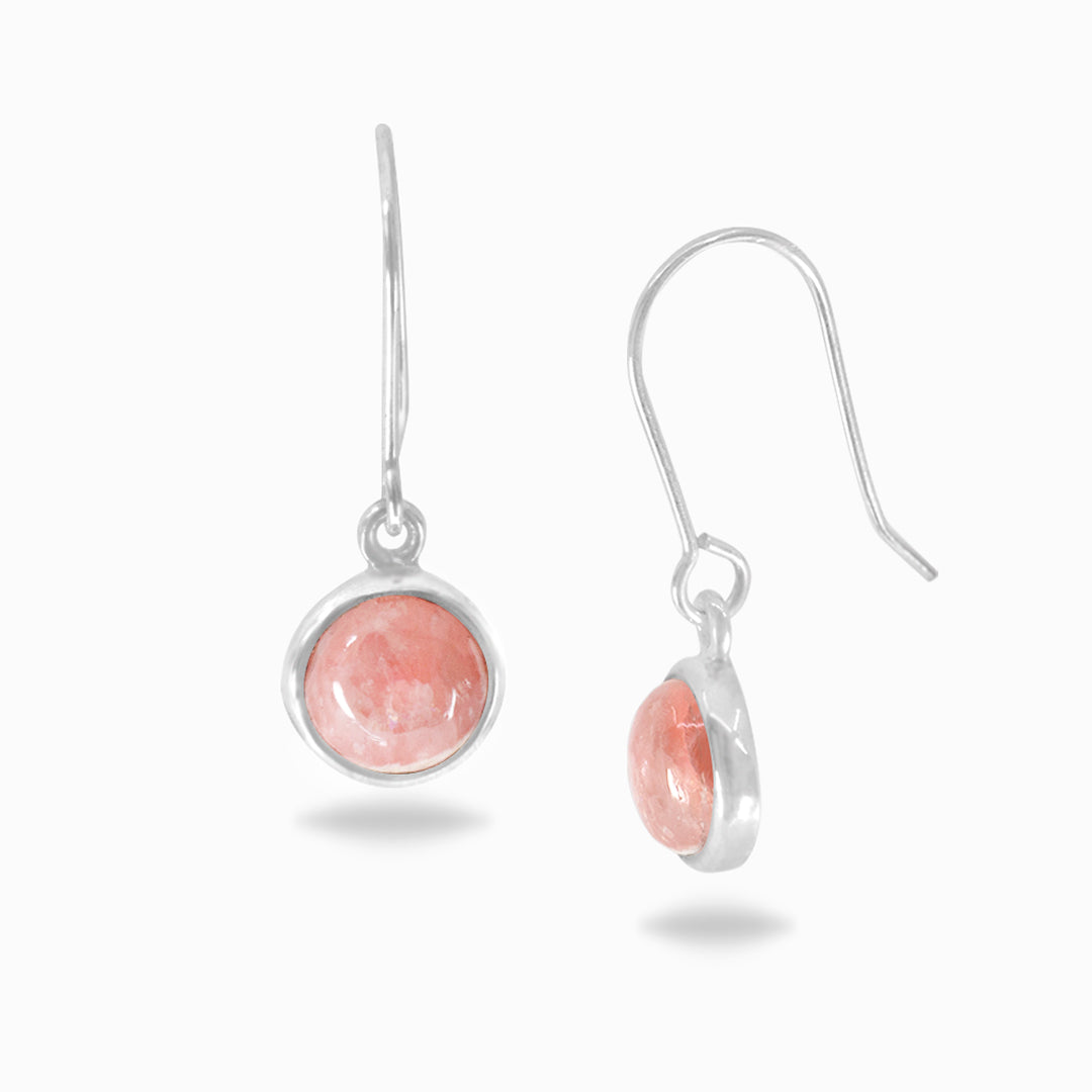 Pair of silver earrings with pink gemstones on a white background
