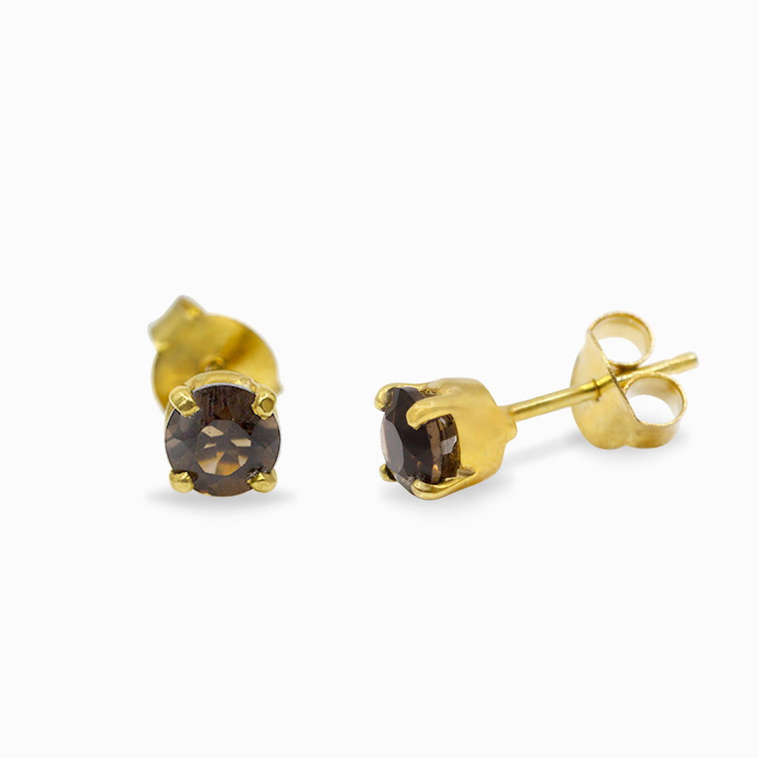 Pair of gold stud earrings with brown gemstones on a white background