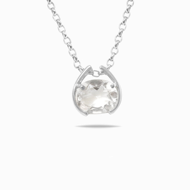 Silver necklace with a clear gemstone pendant on a white background