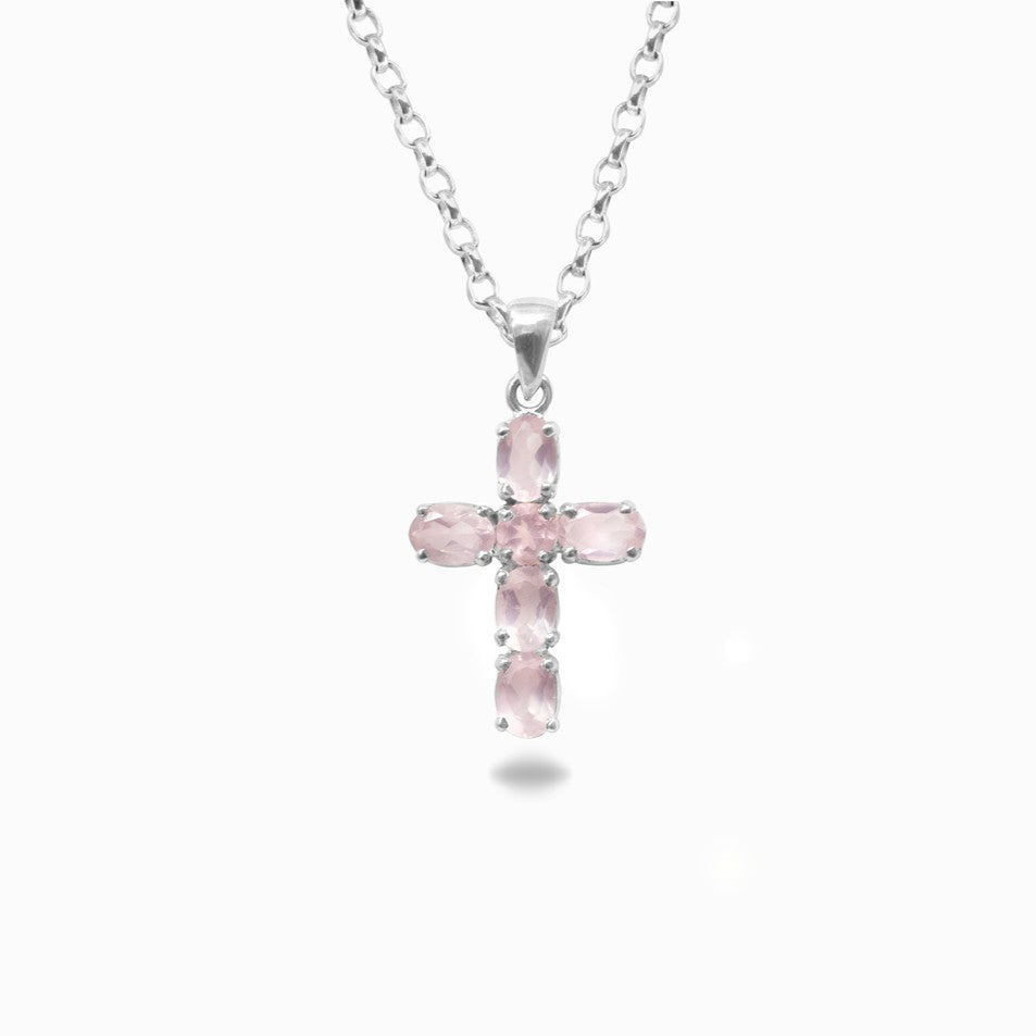 Pink cross pendant necklace on a white background