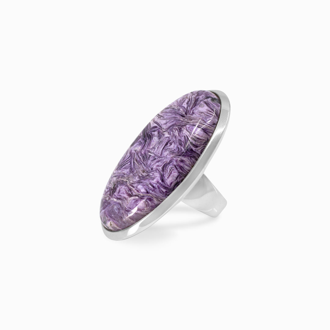 Silver ring with a purple gemstone on a white background