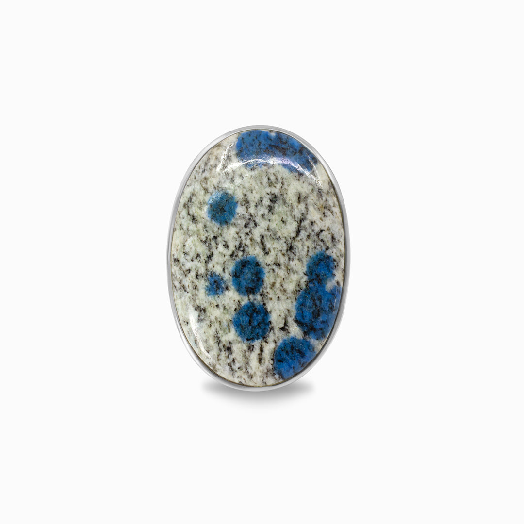 Silver ring with a gemstone with blue and white patterns on a white background