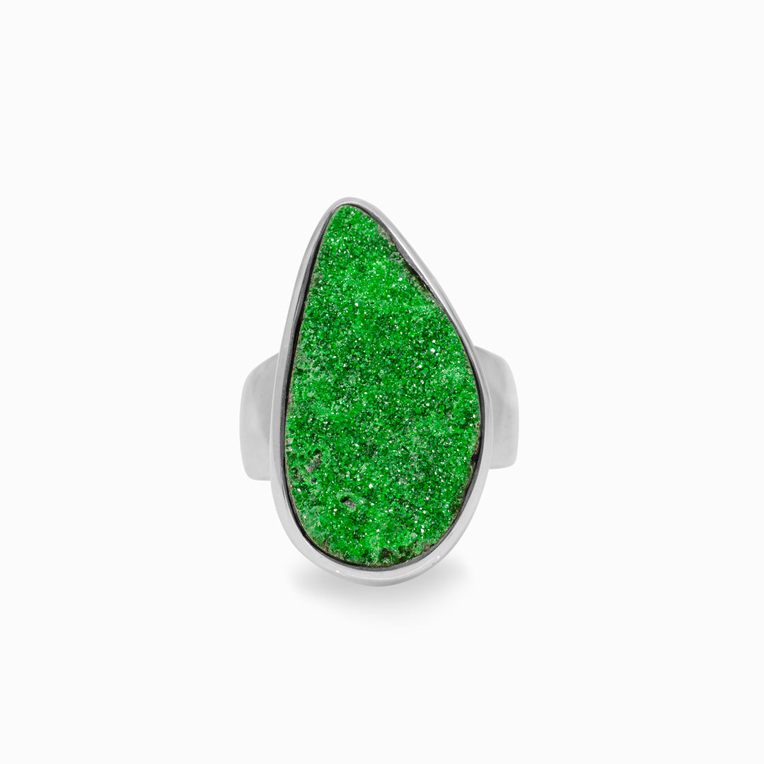 Silver ring with a green stone on a white background