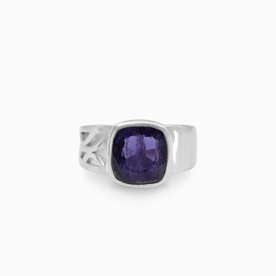 Silver ring with a violet gemstone on a white background