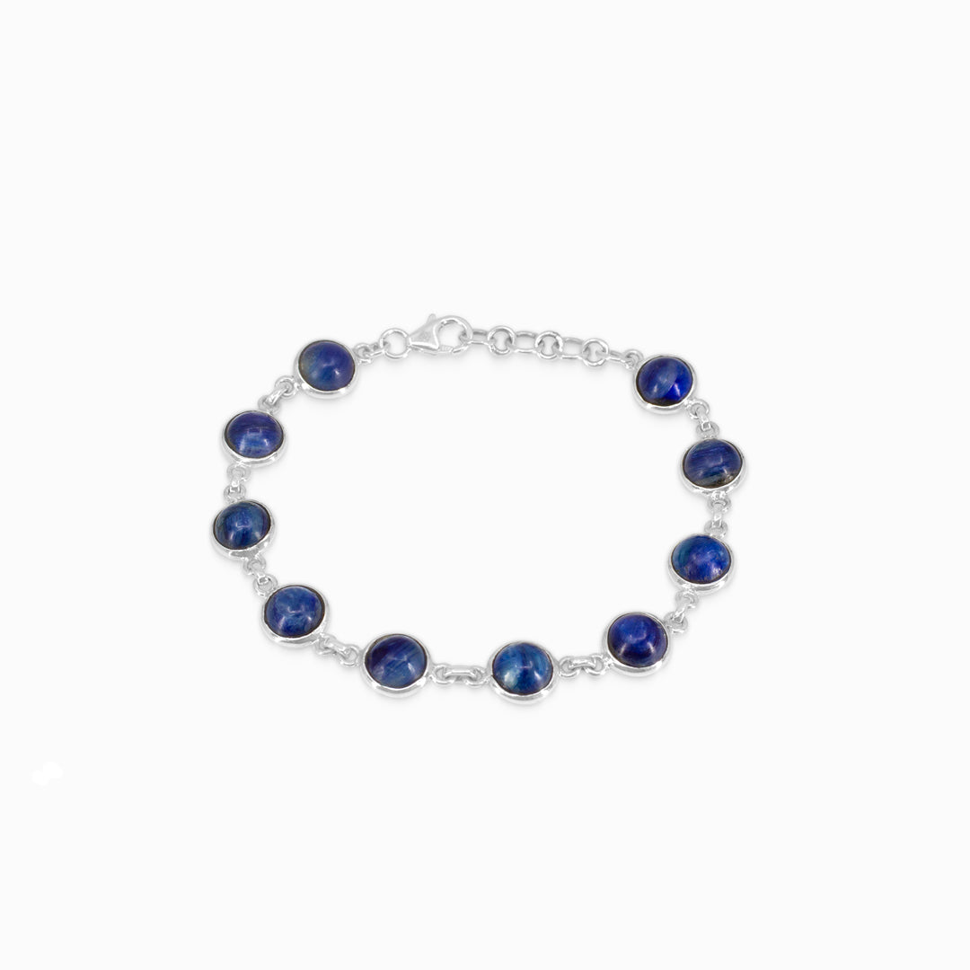 Silver bracelet with blue stones on a white background