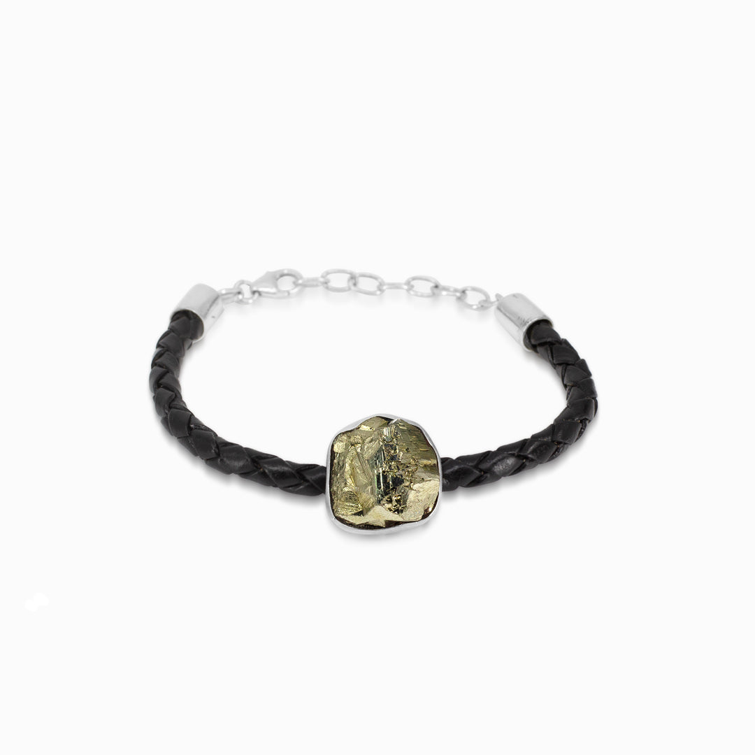 Bracelet with black braided leather strap and gold freeform gemstone on a white background