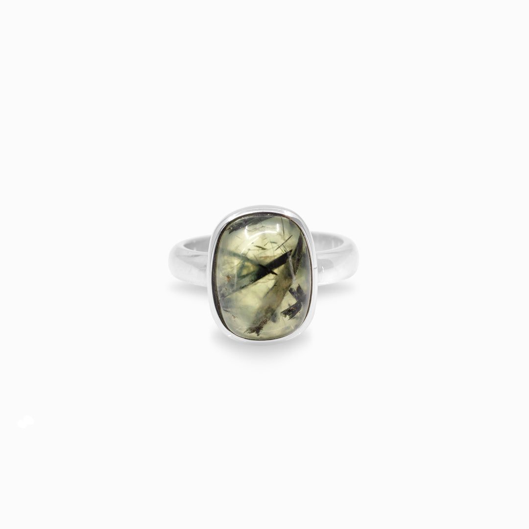 Silver ring with a green gemstone on a white background