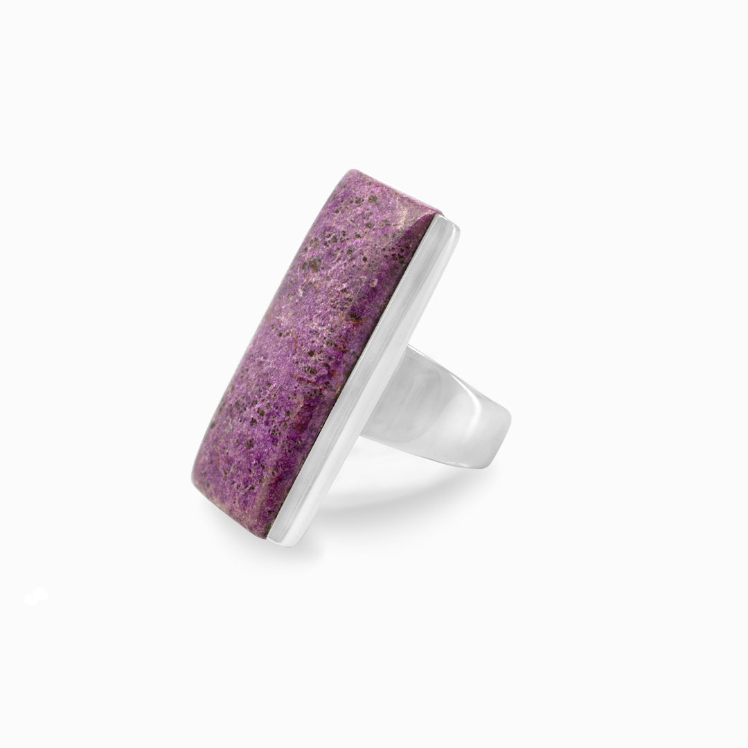 Silver ring with a purple stone on a white background