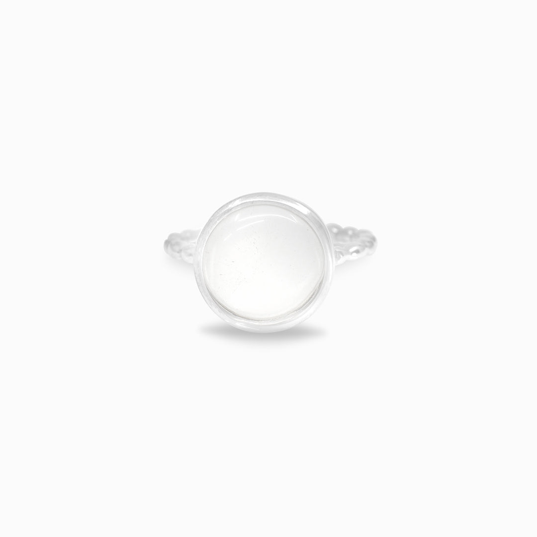 Silver ring with a clear stone on a white background
