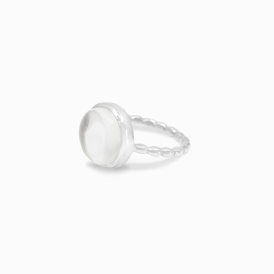 Silver ring with a clear stone on a white background