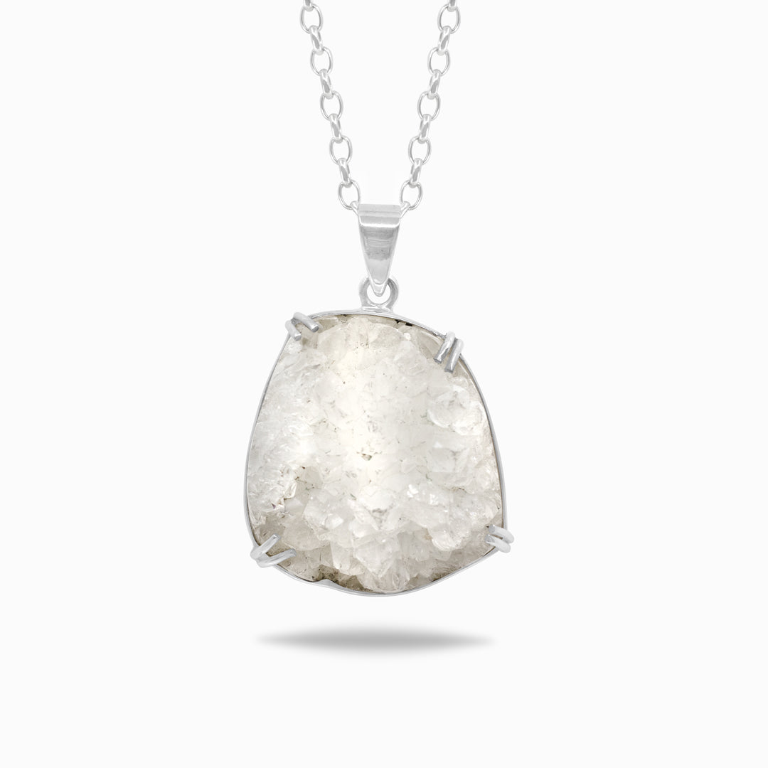 Silver necklace with a druzy clear stone on a white background