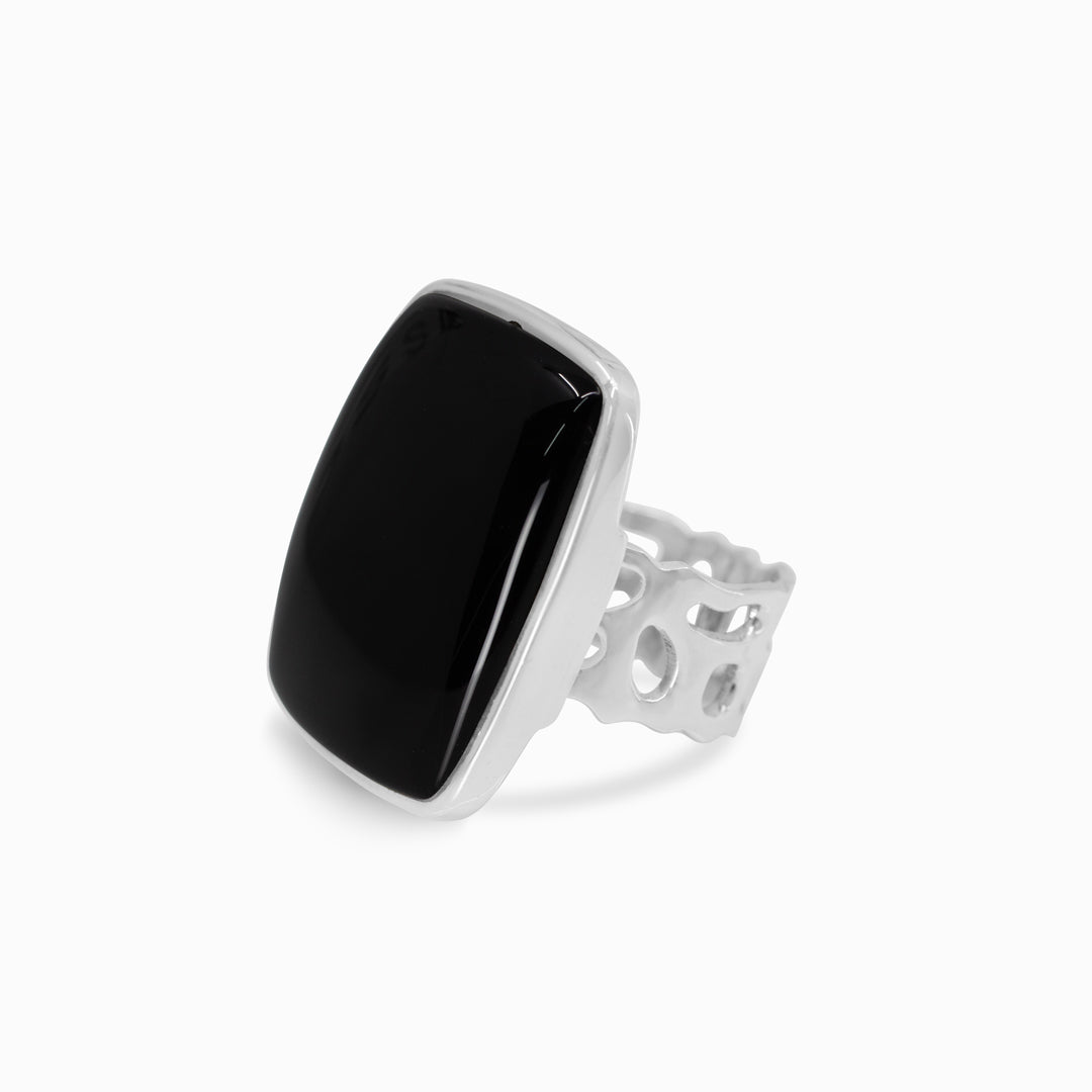 Silver ring with a black stone on a white background