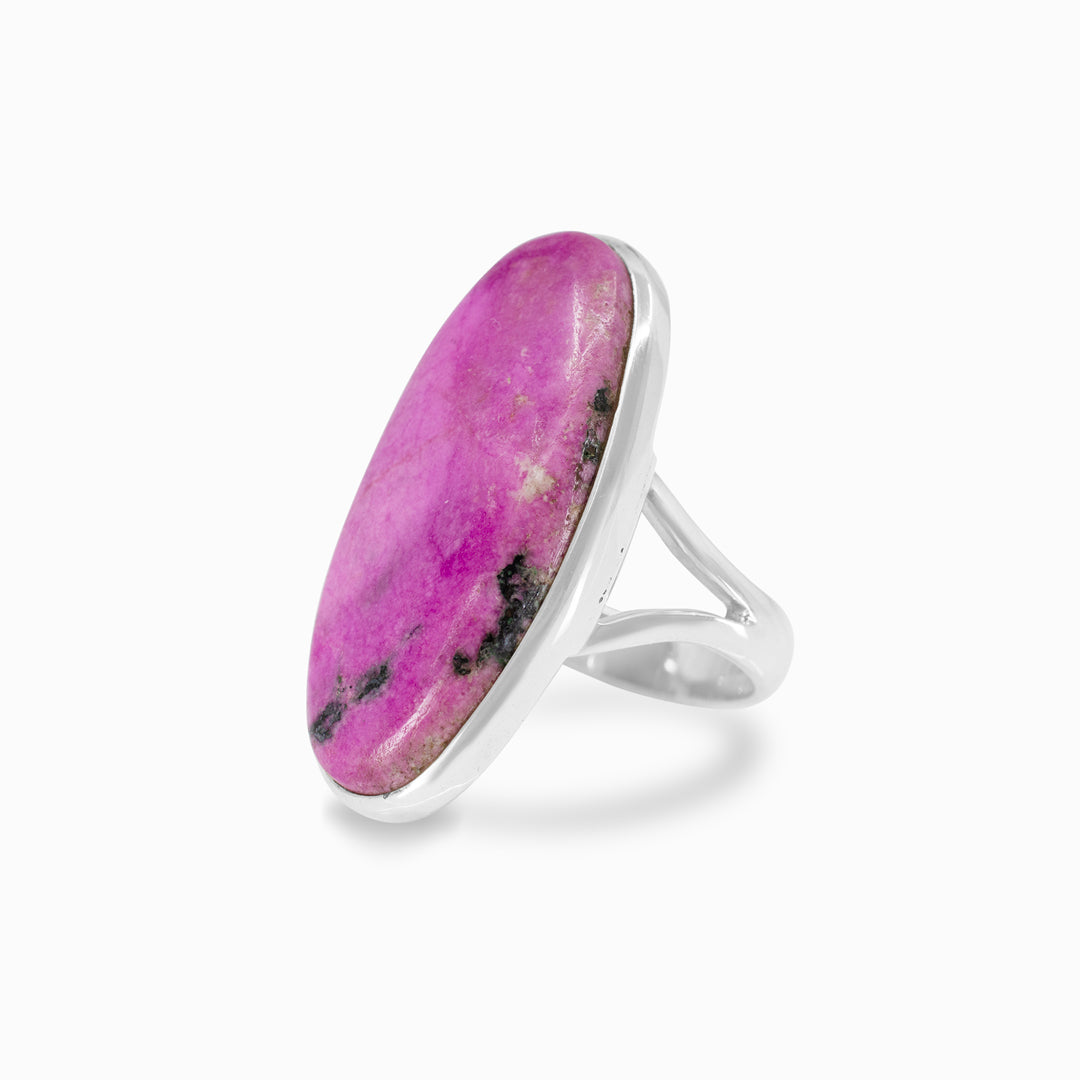 Silver ring with pink gemstone on a white background