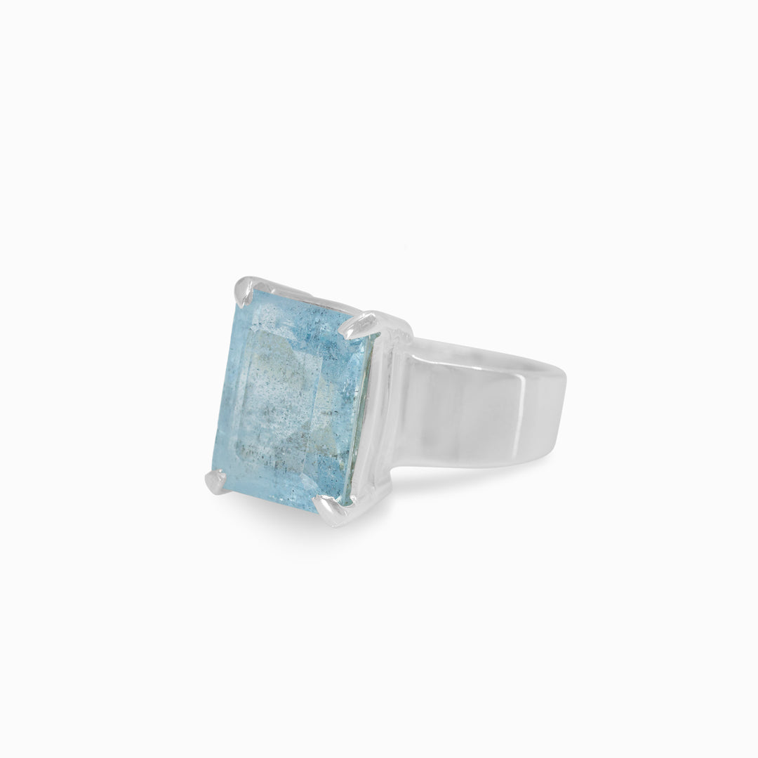 Silver ring with a rectangular blue gemstone on a white background