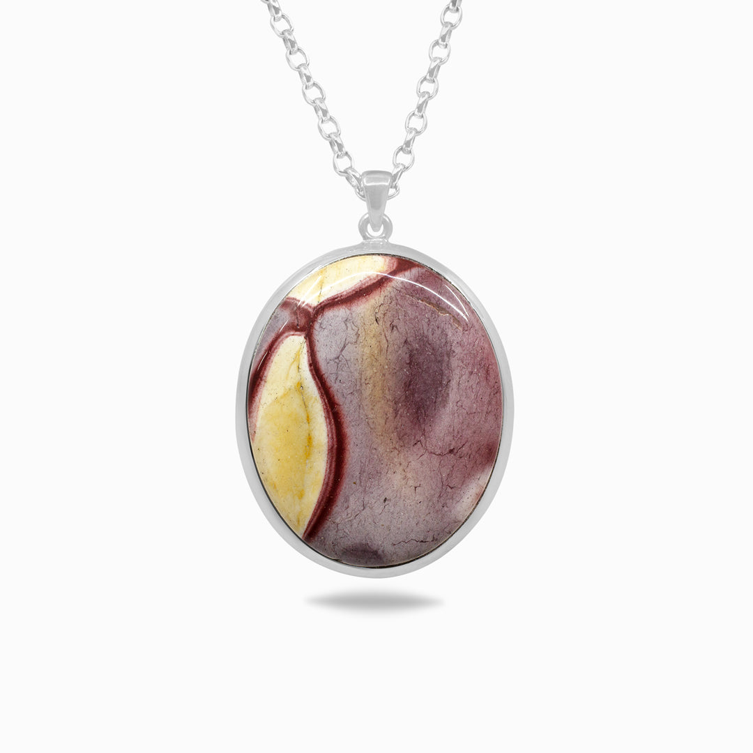 Silver necklace with a red and yellow stone on a white background