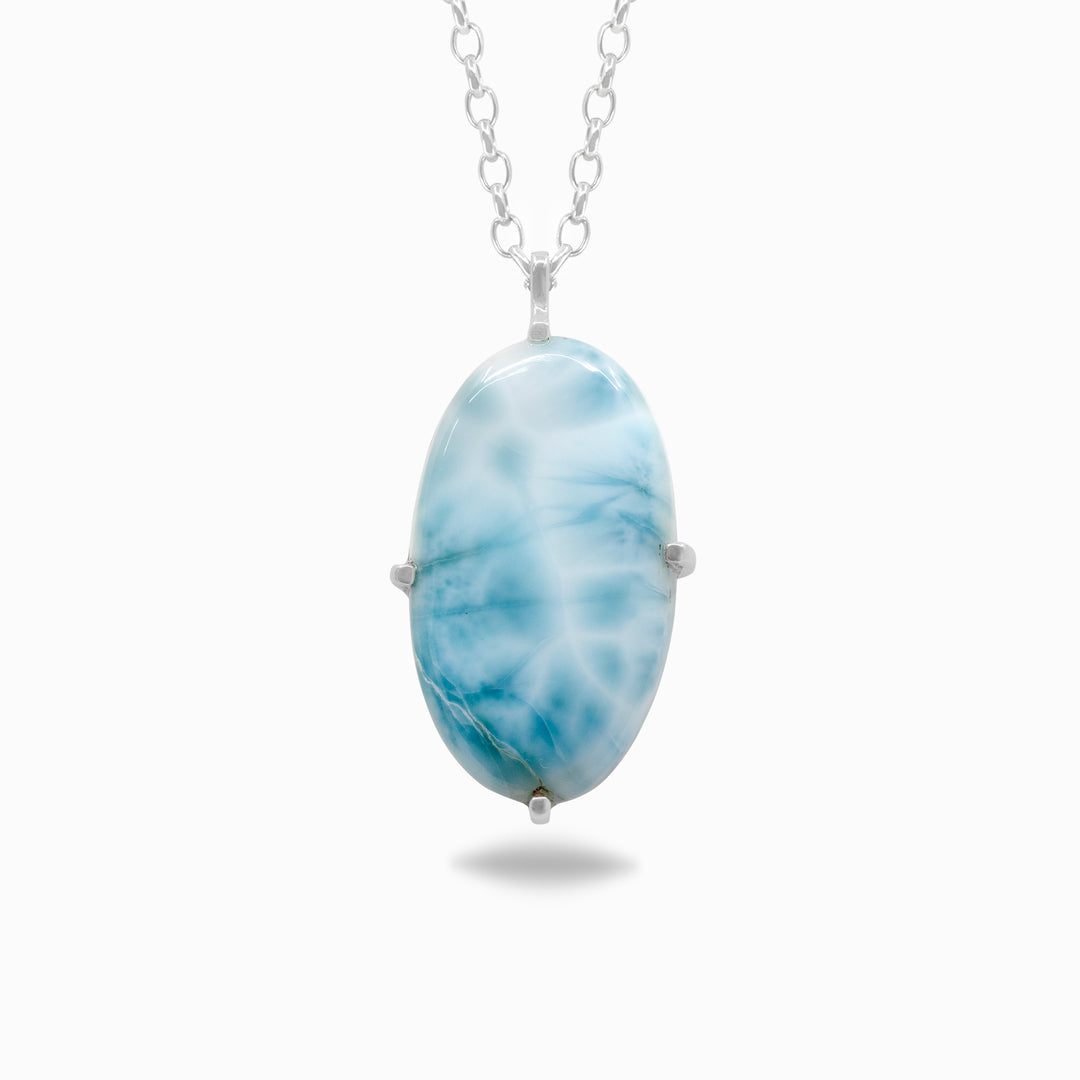 Silver necklace with light blue and white gemstone on a white background