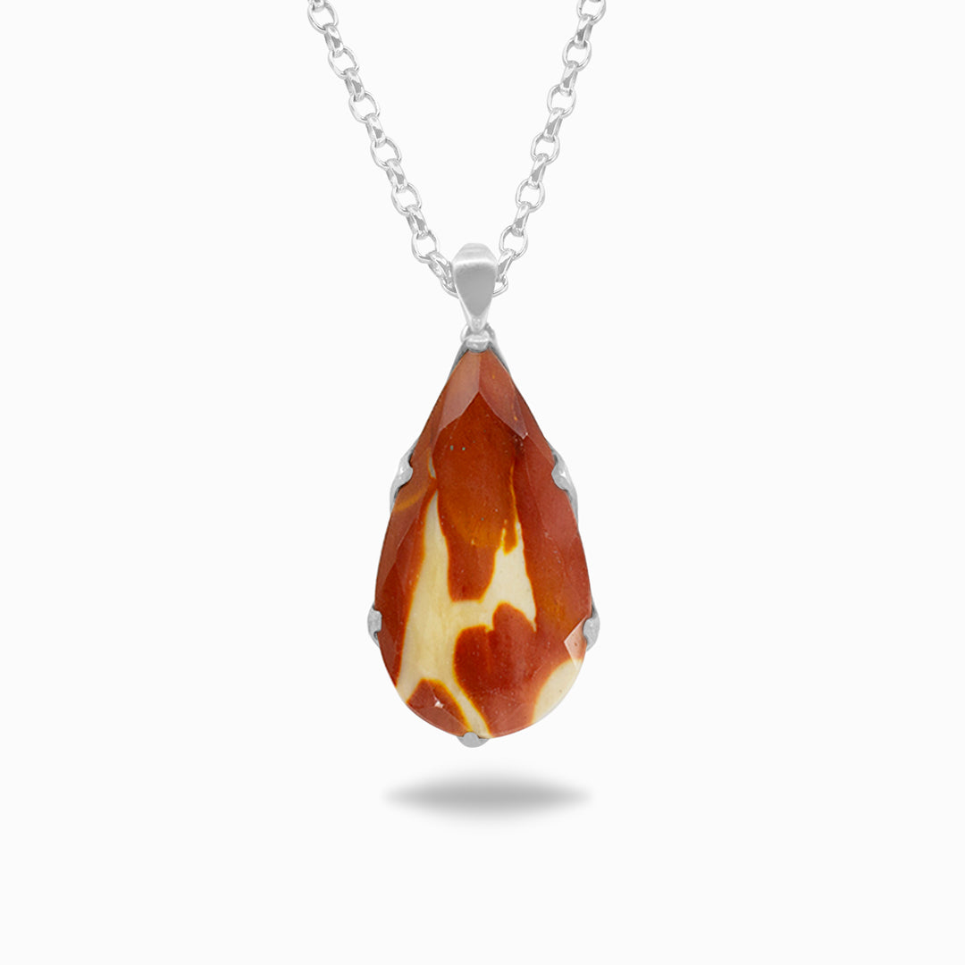 Silver necklace with a red and yellow stone on a white background