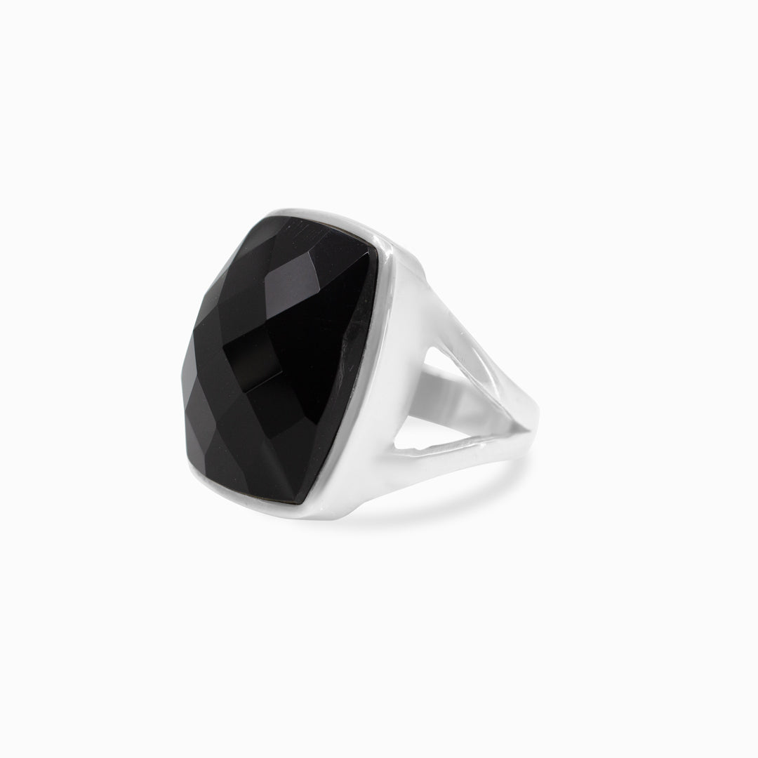 Silver ring with a black gemstone on a white background