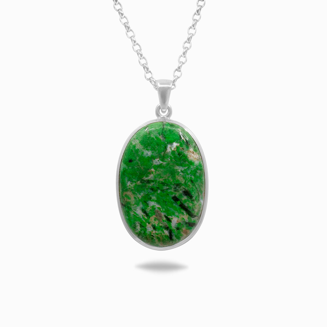 Silver necklace with a green gemstone on a white background