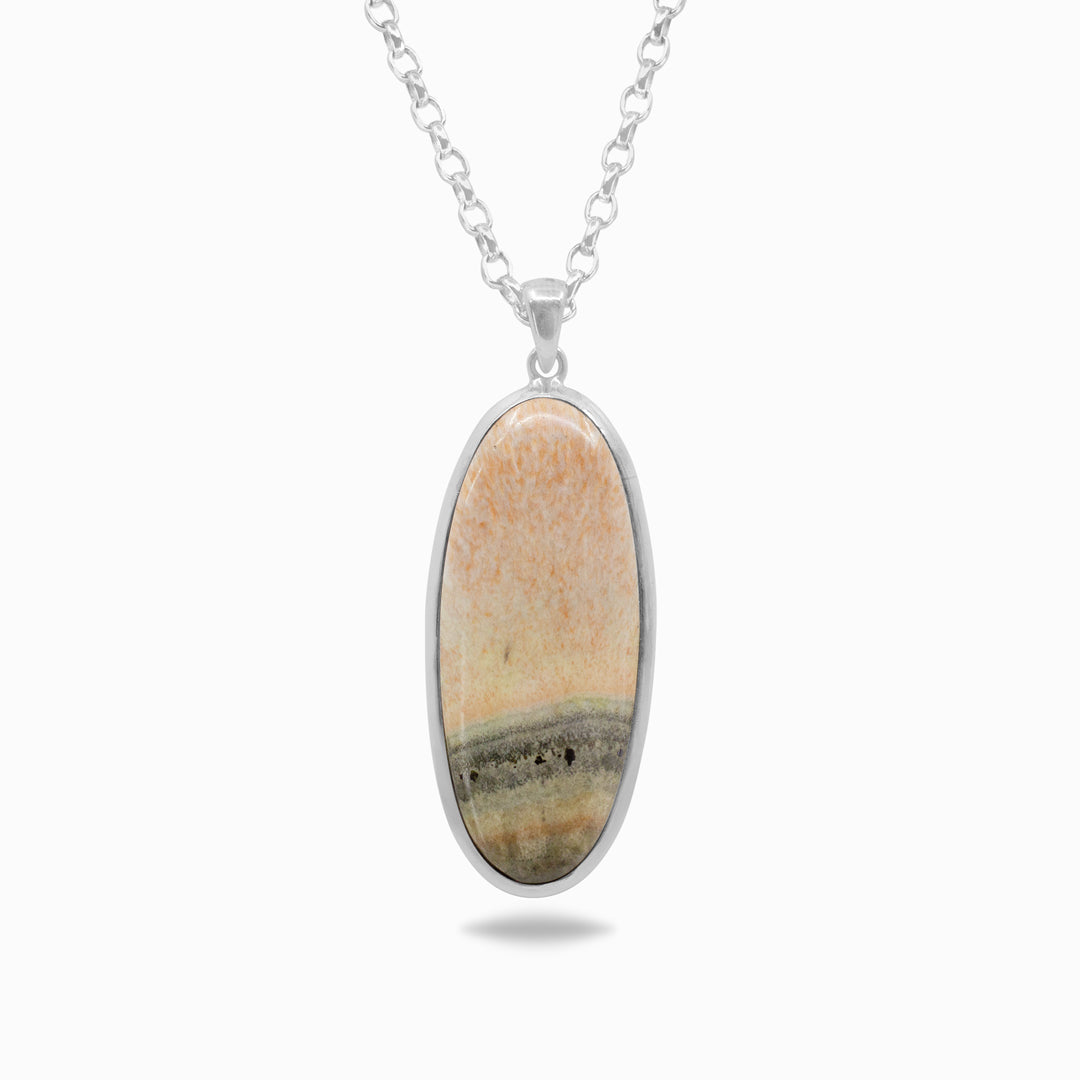 Silver necklace with a stone with salmon-pink tones and soft grey banding on a white background