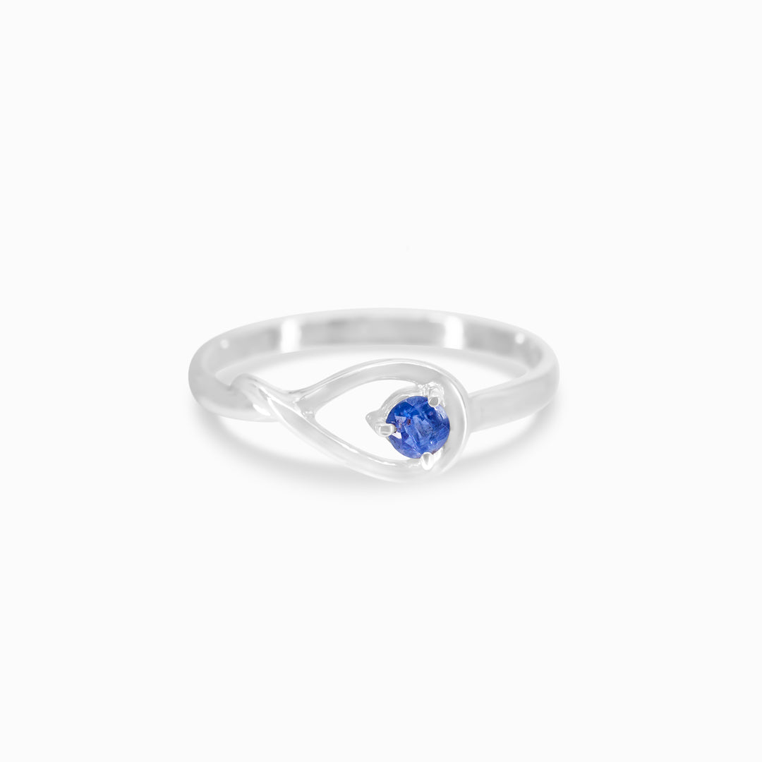 Silver ring featuring a blue gemstone, set against a white background.
