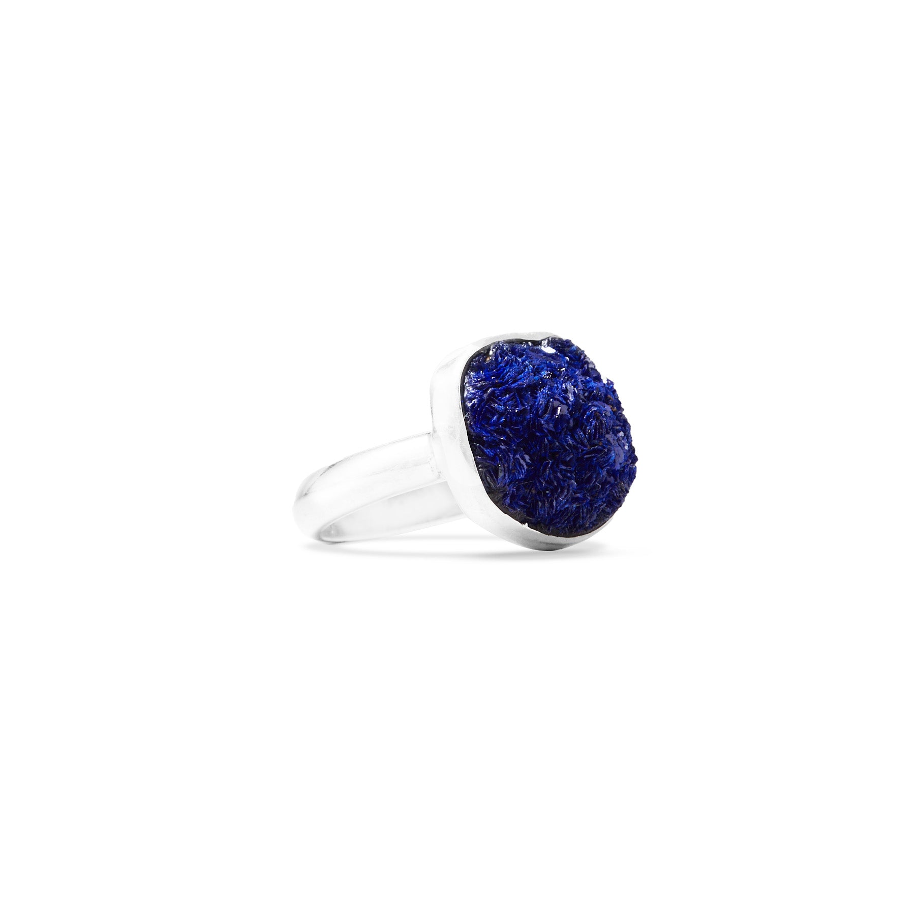 Silver ring with a navy blue gemstone on a white background