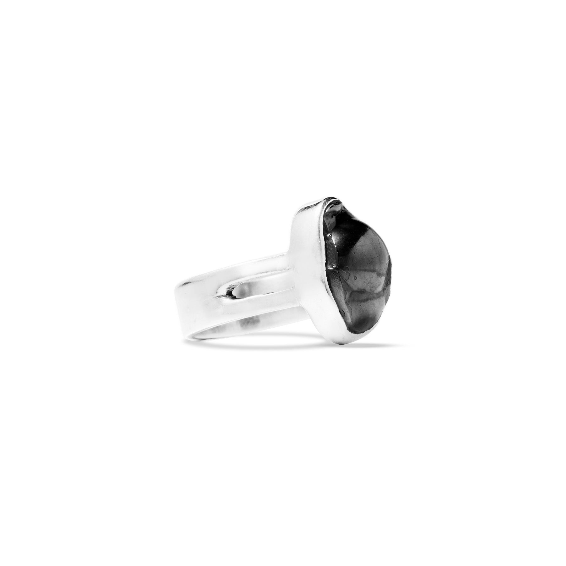 Silver ring with a black metallic gemstone on a white background