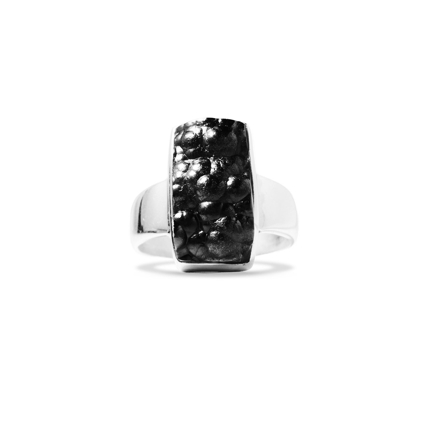 Silver ring with a black metallic gemstone on a white background
