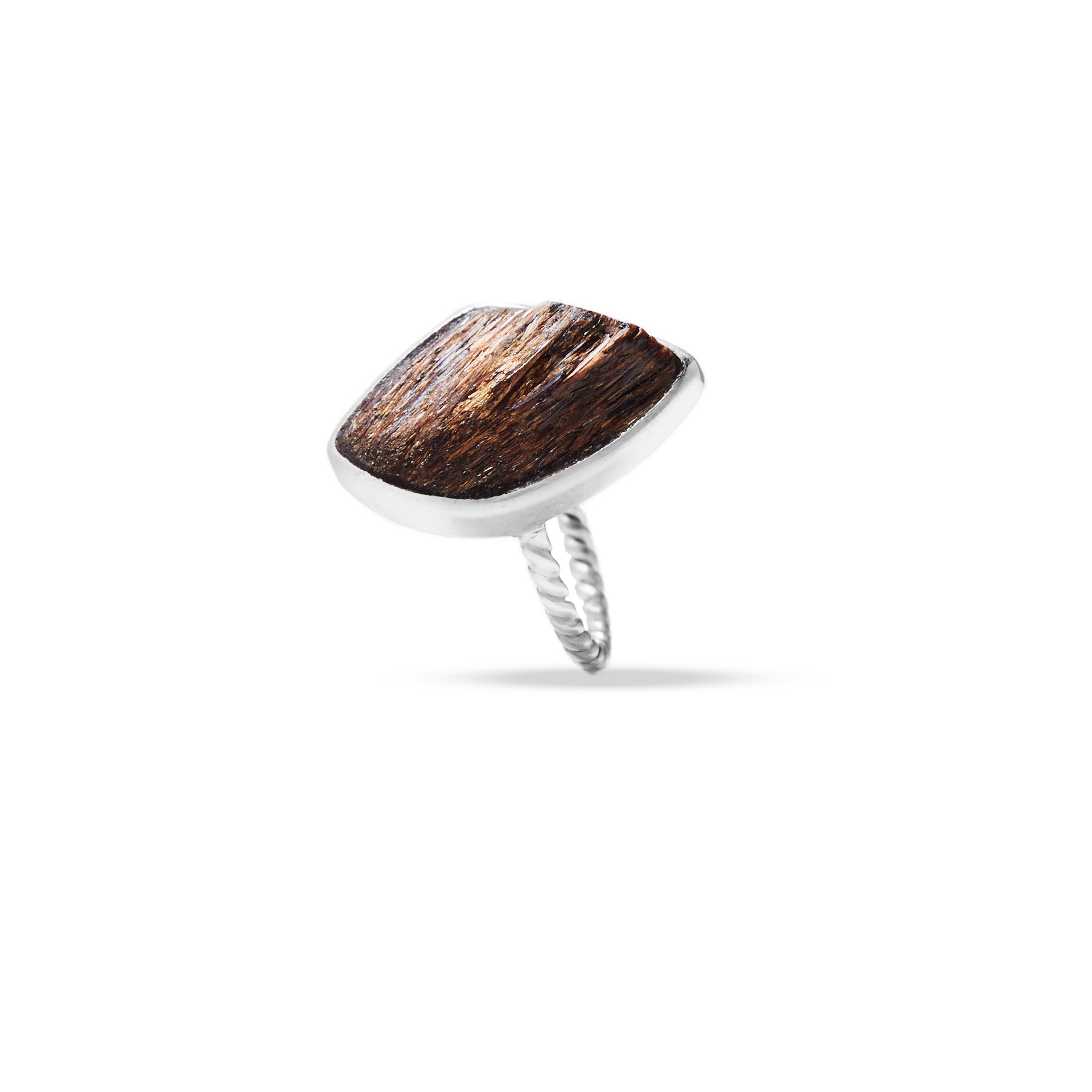 Silver ring with a metallic stone on a white background