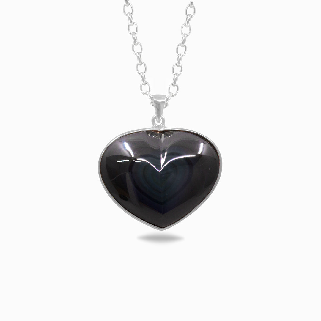 Silver necklace with a black heart-shaped pendant on a white background