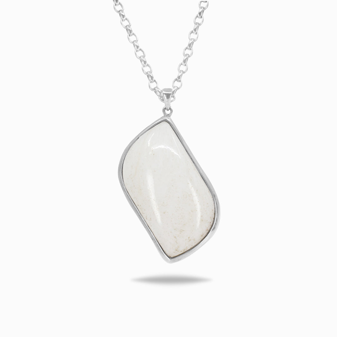 Silver necklace with a white stone pendant on a white background