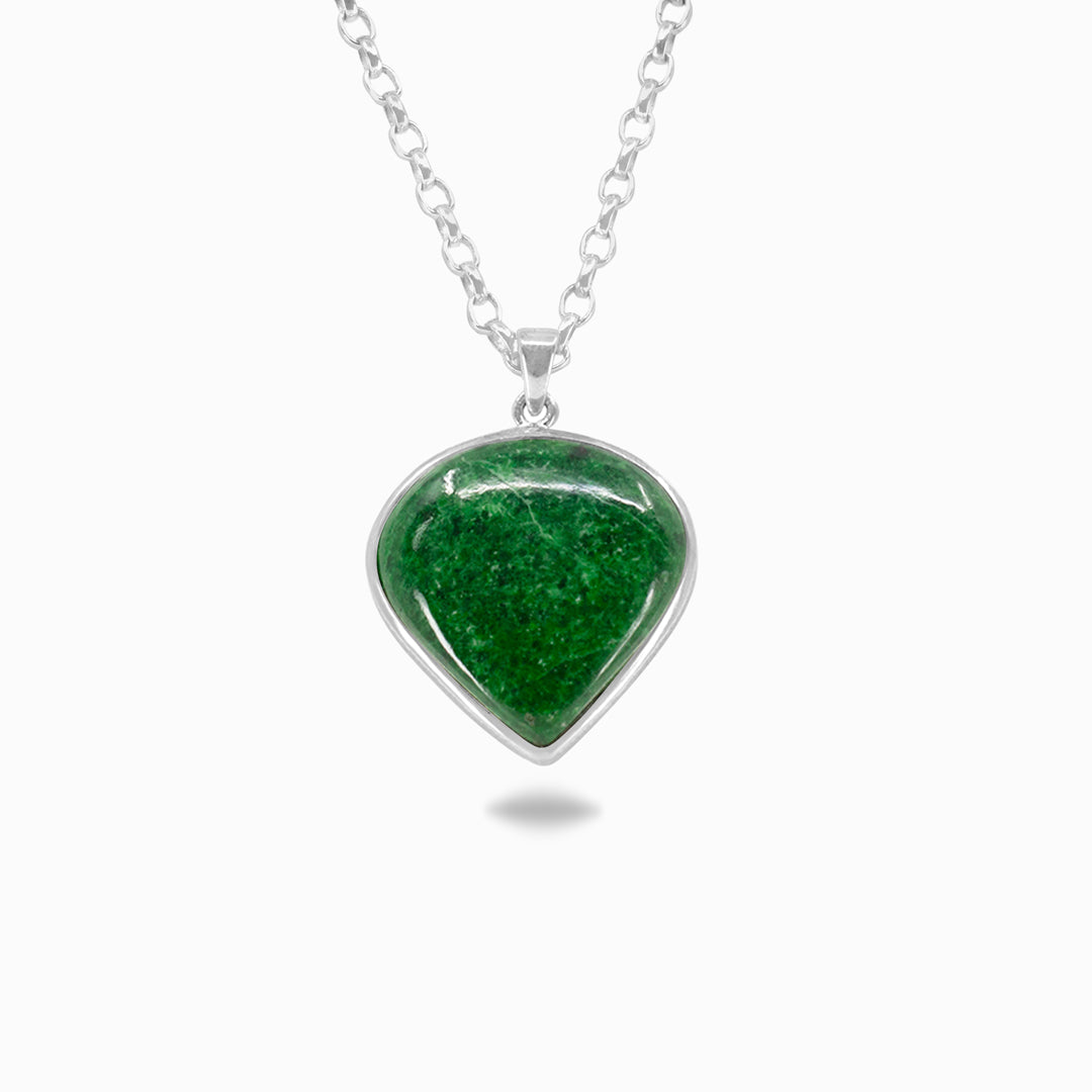 Silver necklace with a dark green gemstone against a white background