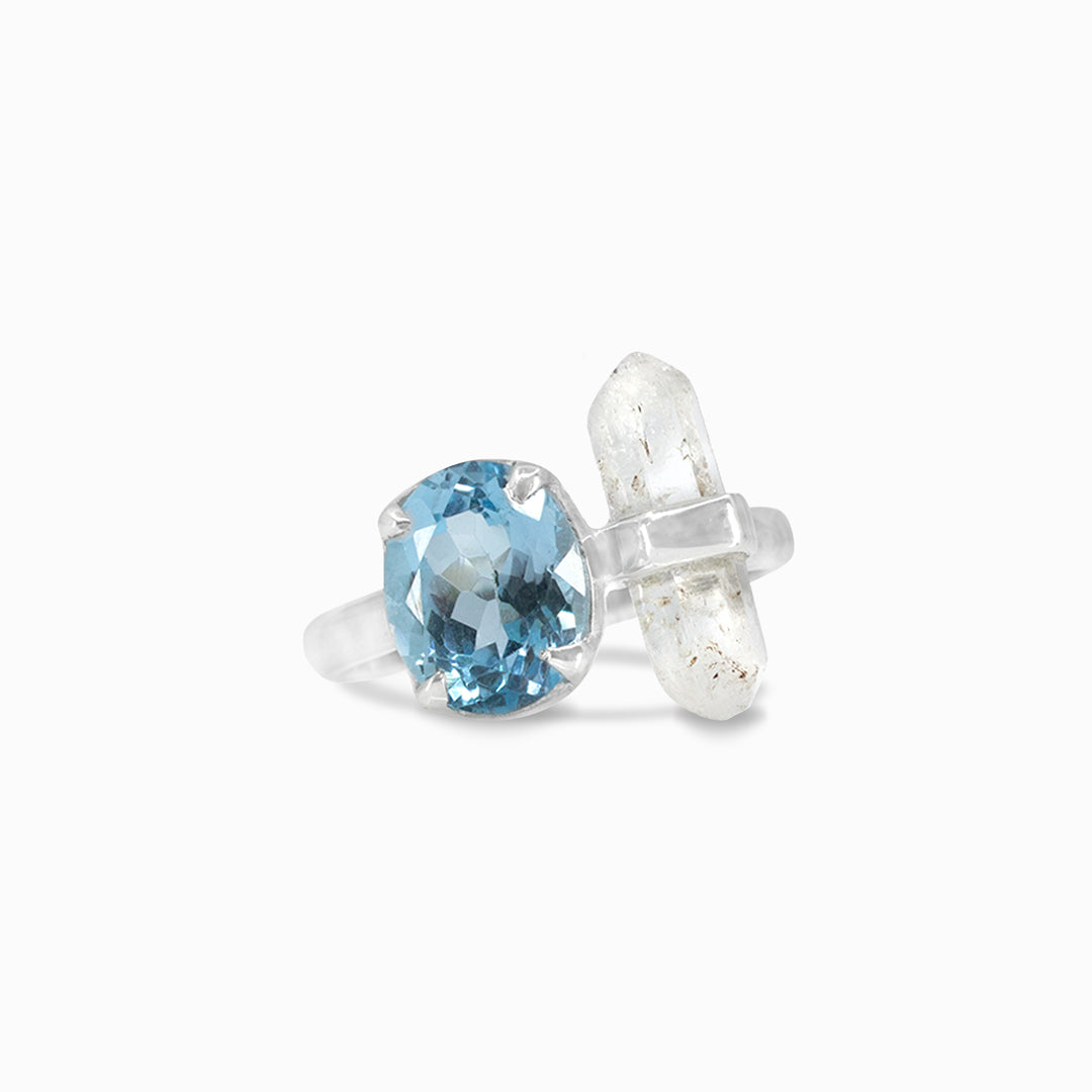 Silver ring with blue and clear gemstones on a white background