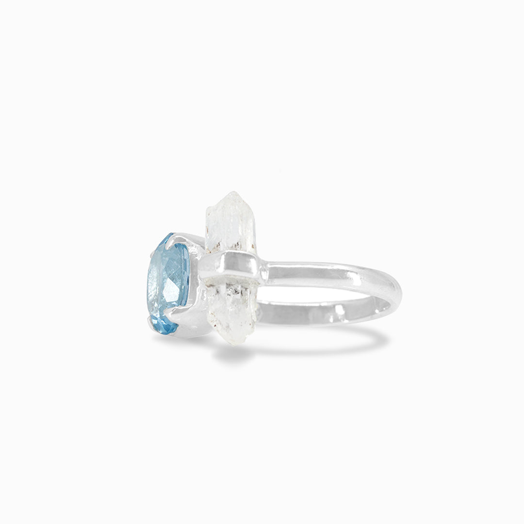 Silver ring with blue and clear gemstones on a white background