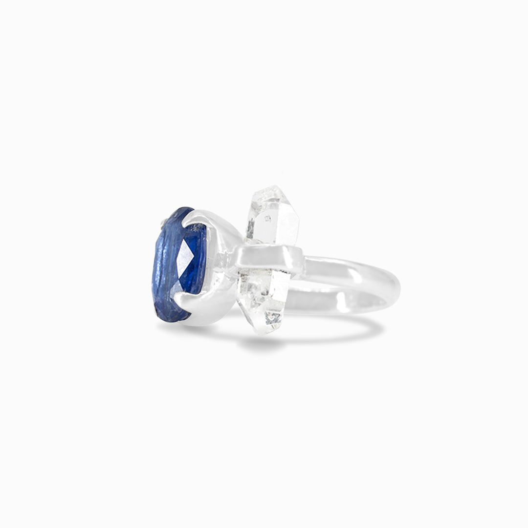 Silver ring with blue and clear gemstones on a white background