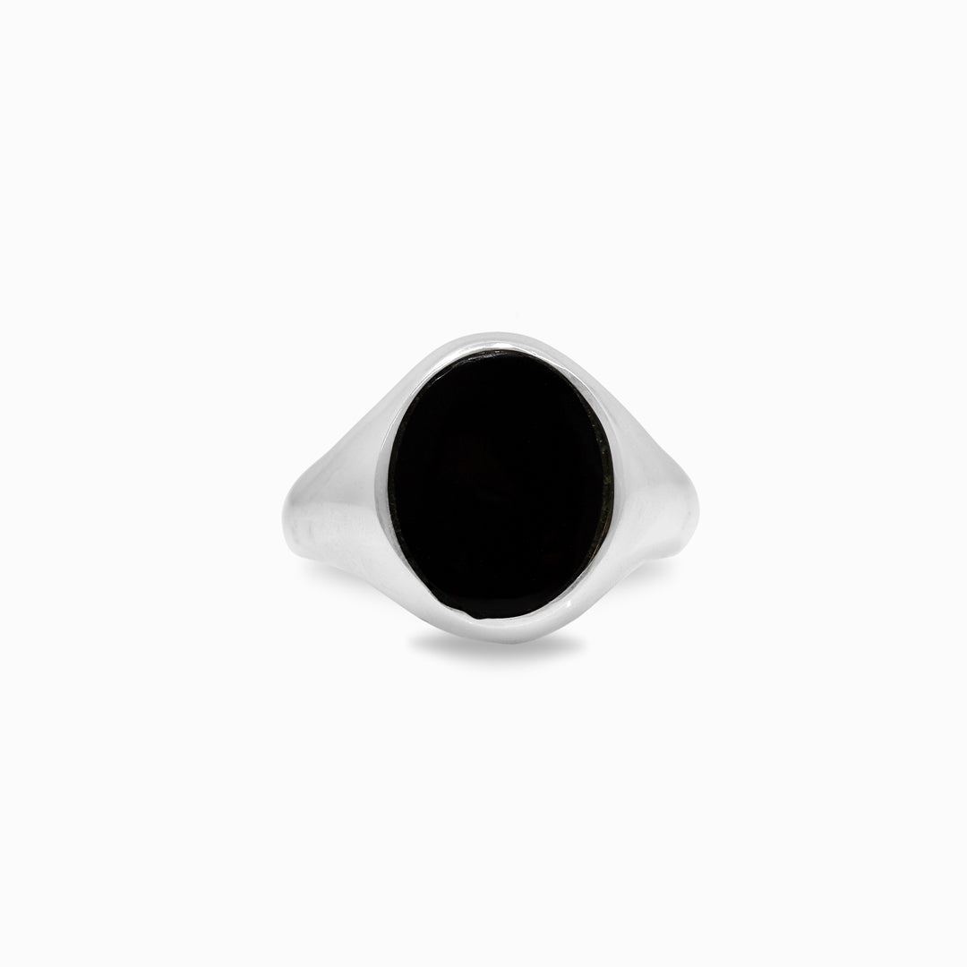 Silver ring with a black stone on a white background
