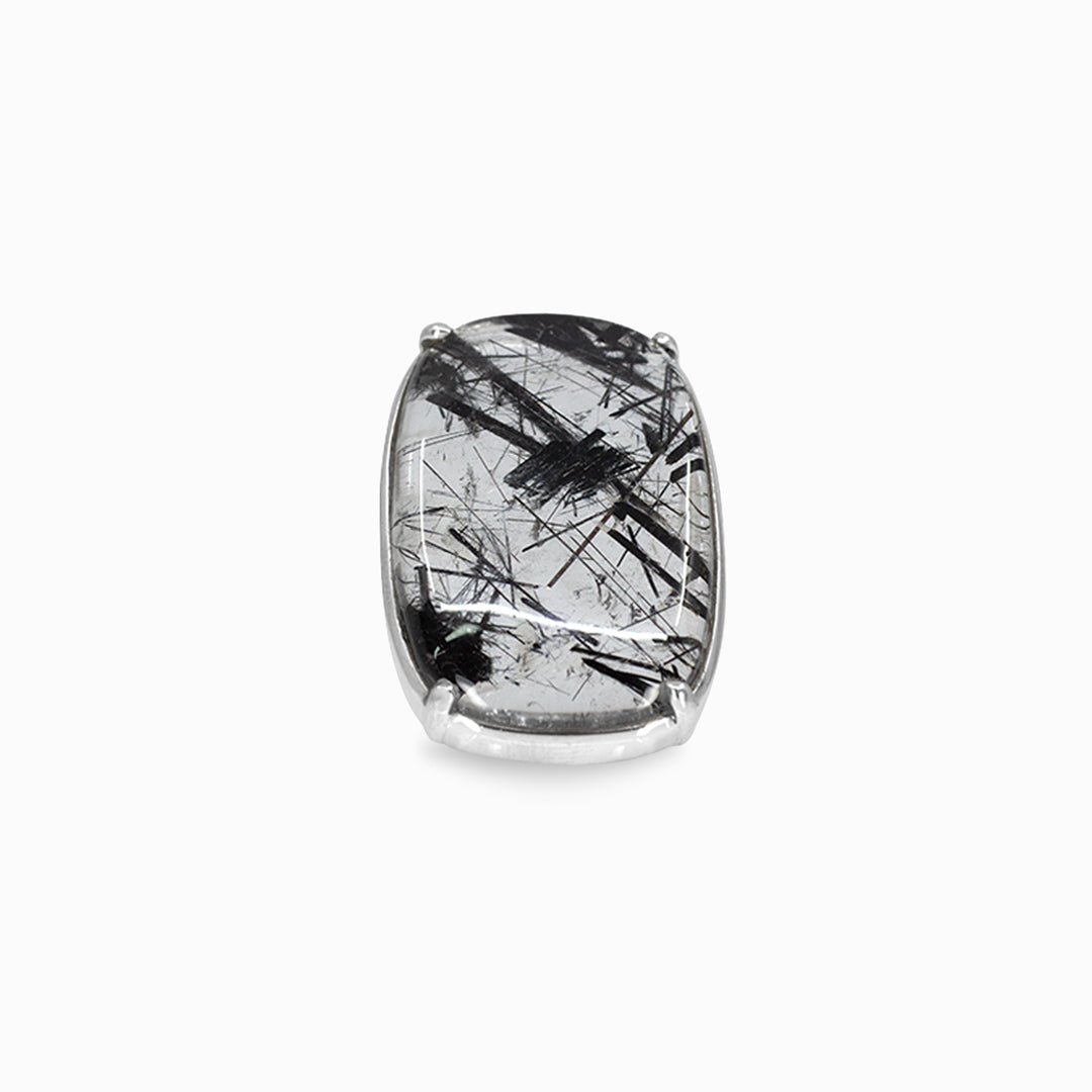 Silver ring with a black and clear patterned stone on a white background